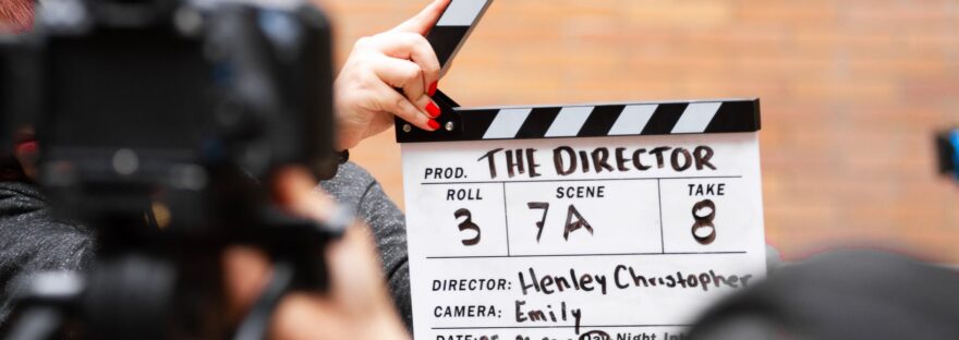 man holding clapper board