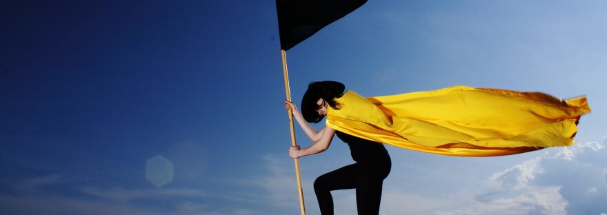 woman holding black flag