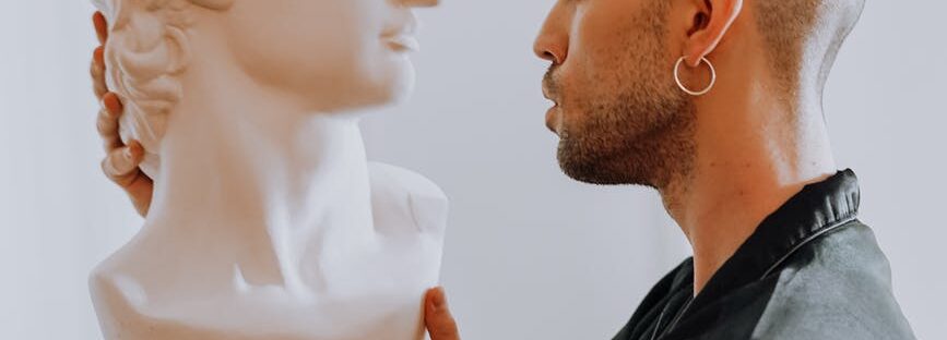 man holding gypsum head