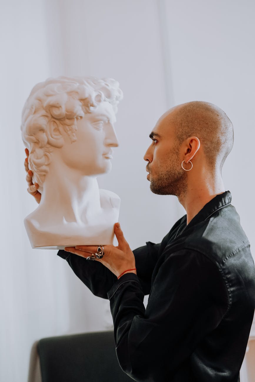 man holding gypsum head