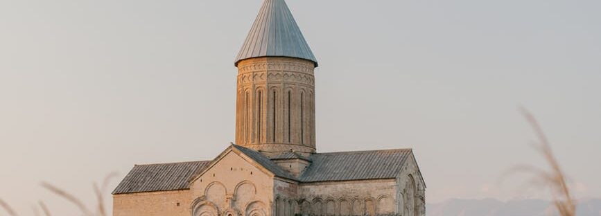 old church with cross on top of roof