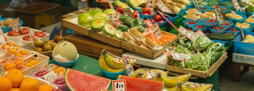 colorful fruits and vegetables placed on counter in local market