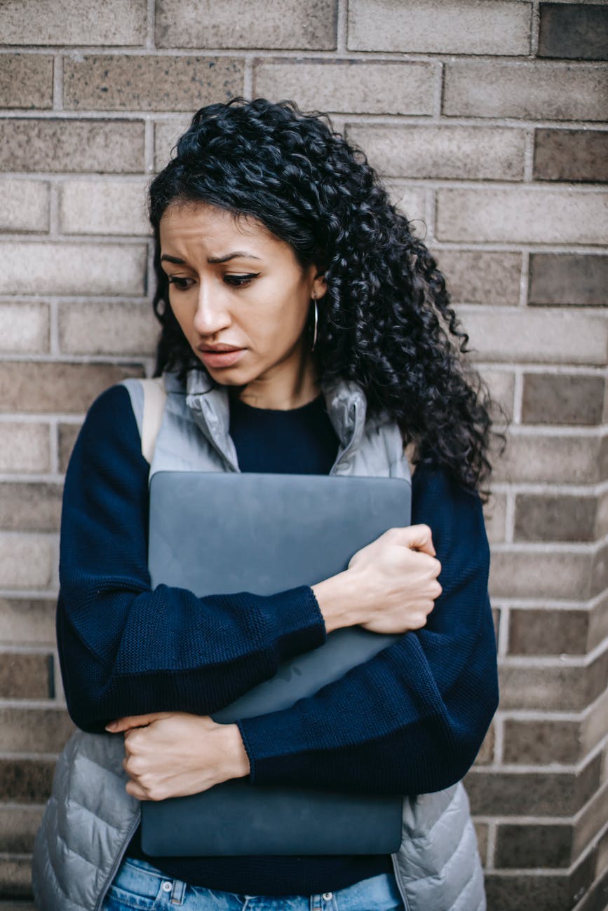 unhappy latin american woman with laptop