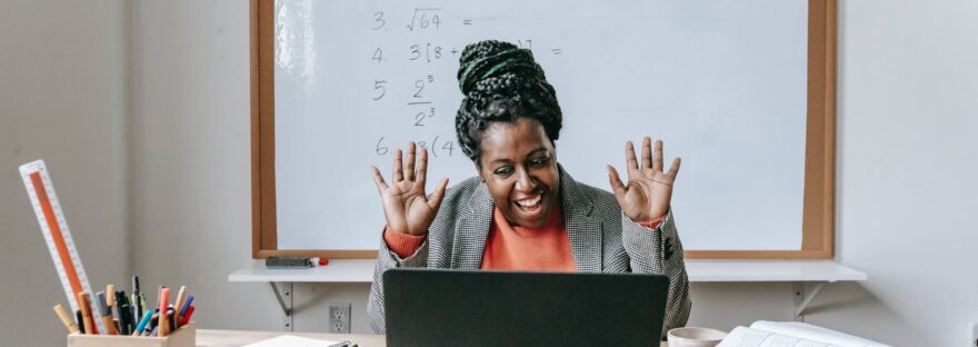 happy black woman using laptop for online work