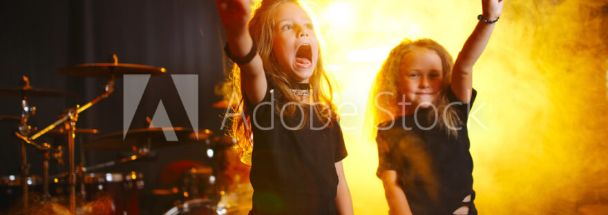 little girl play on synthesizer in music studio