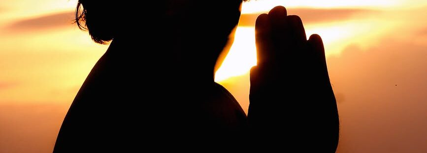 silhouette image of person praying