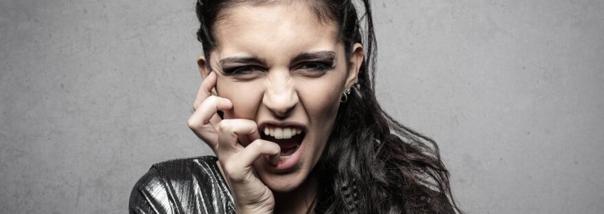 stylish female rocker screaming in studio
