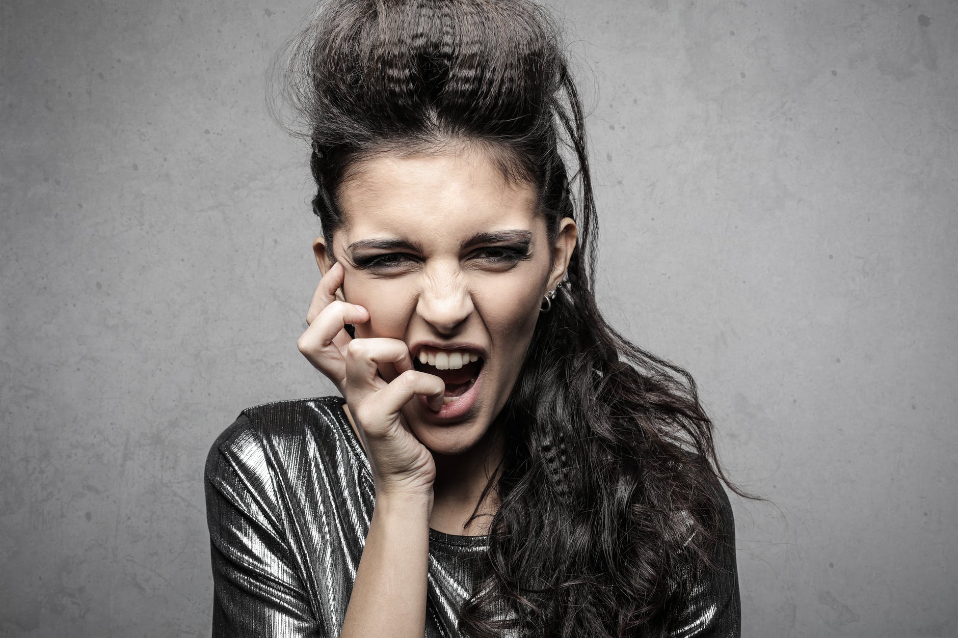 stylish female rocker screaming in studio