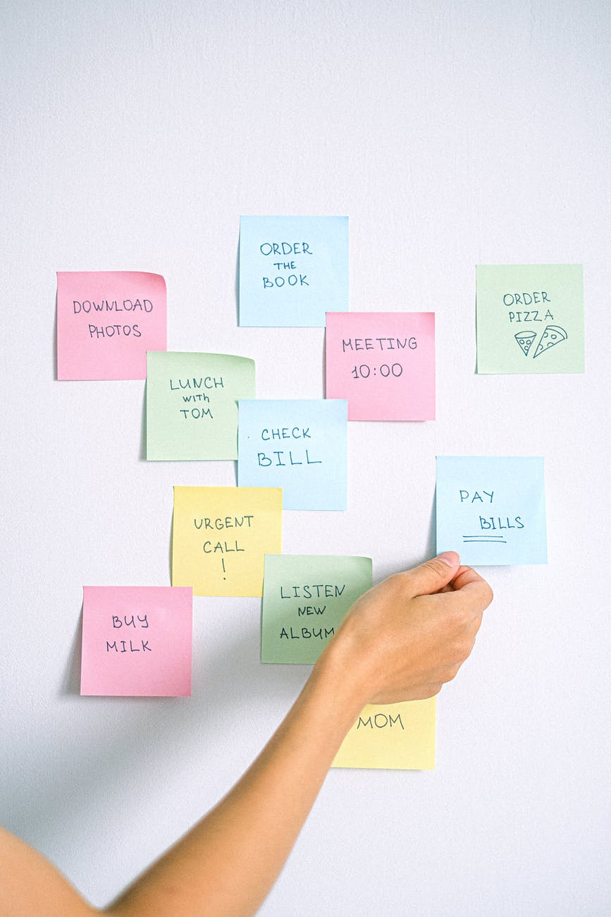 person holding yellow sticky notes