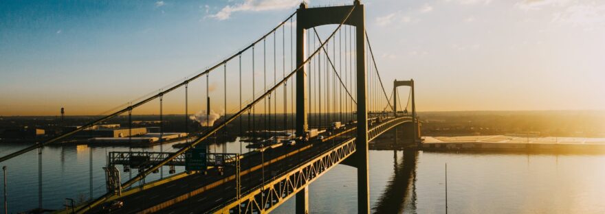majestic suspension bridge over river in bright sunshine