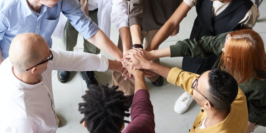 photo of people holding each other s hands