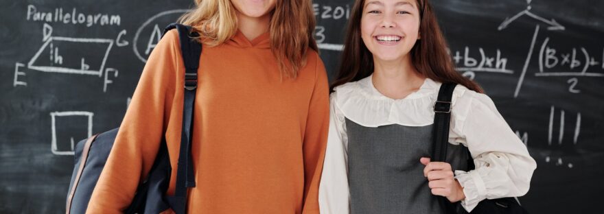 girls smiling while looking at camera