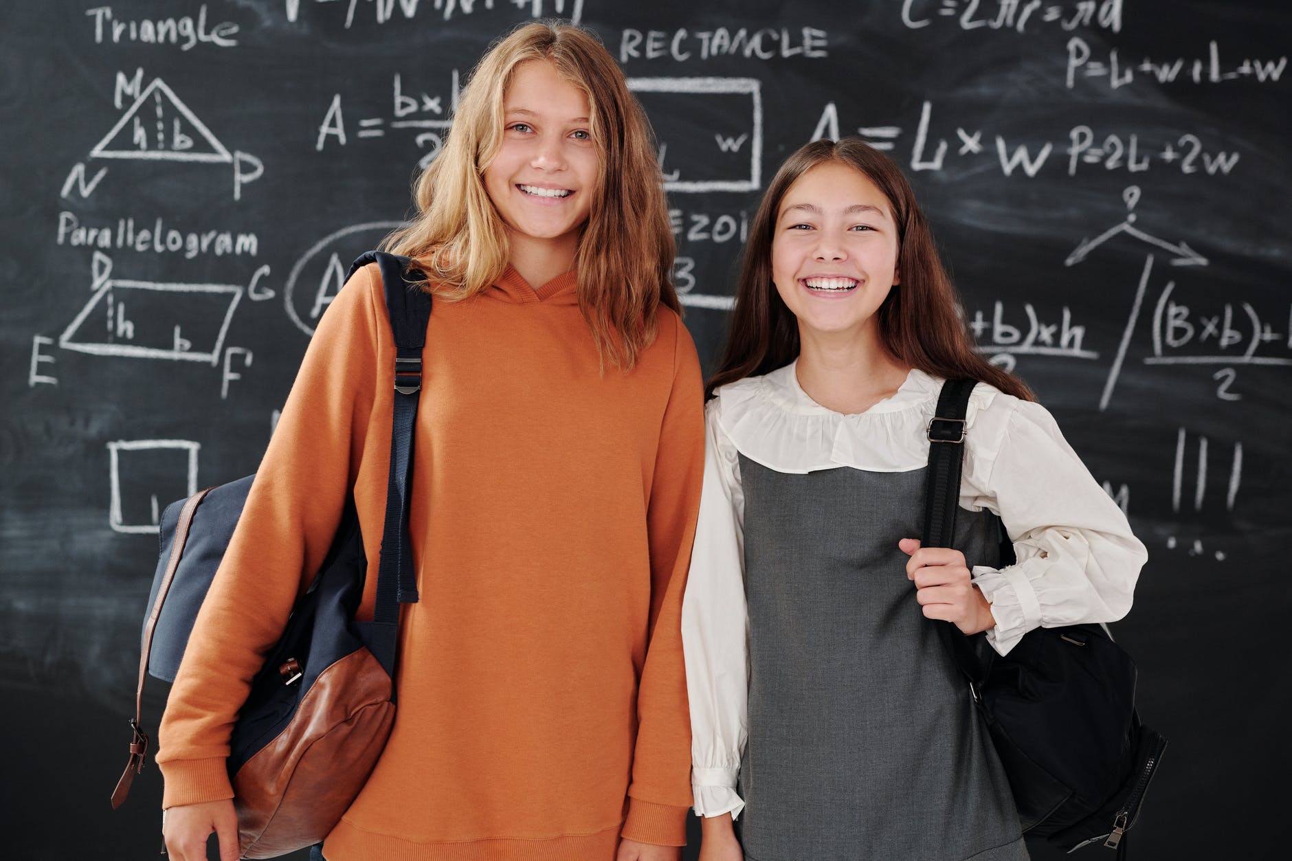 girls smiling while looking at camera
