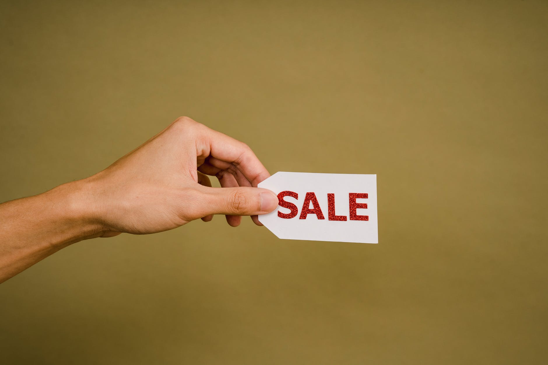 crop faceless person demonstrating sign sale