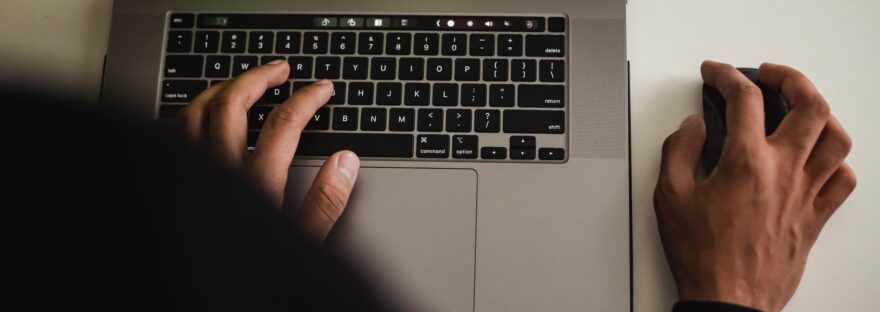 crop faceless programmer working on laptop in studio