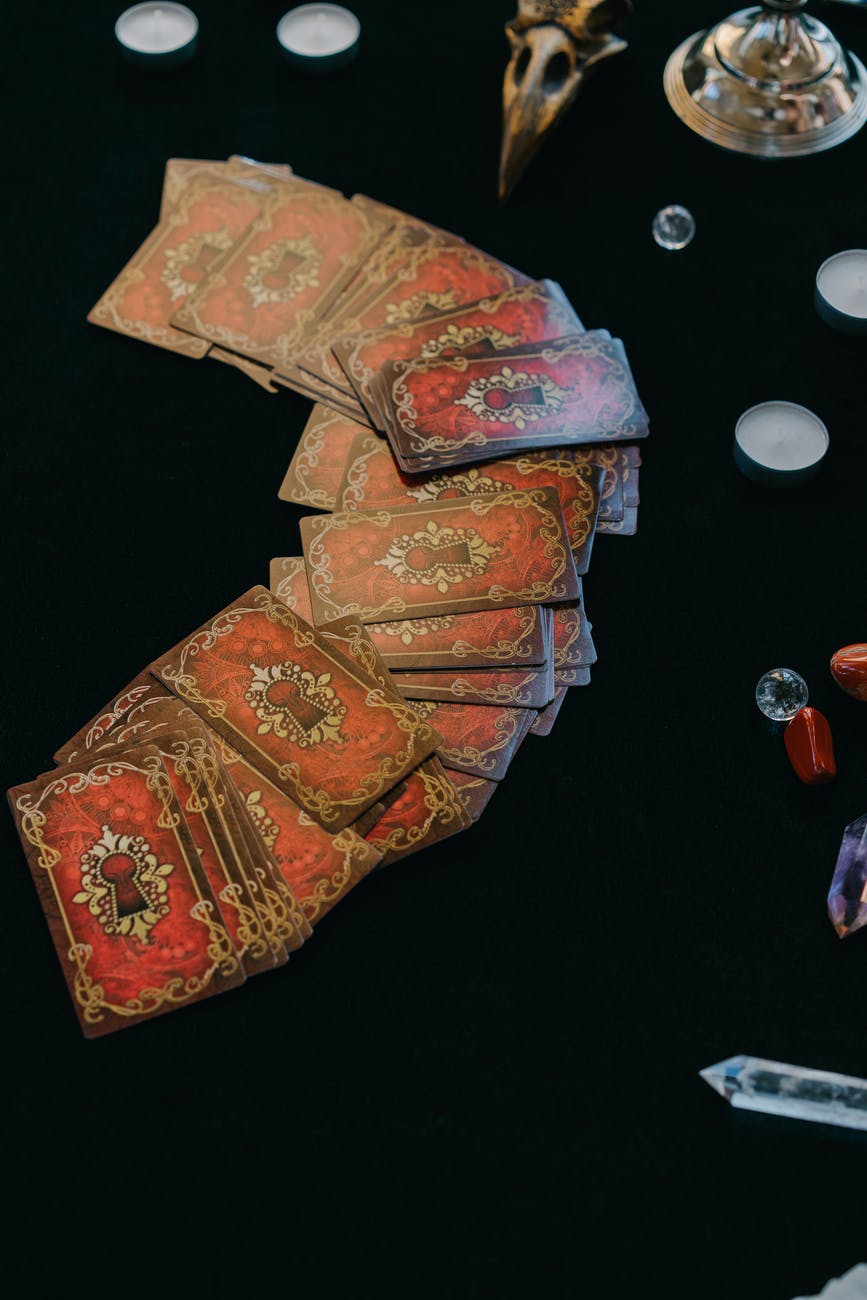 deck of cards and candles with crystals for divination