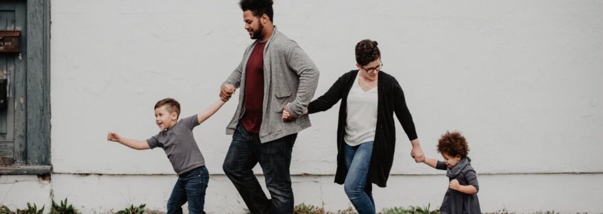 family of four walking at the street