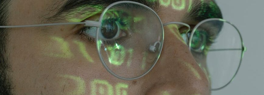 man with binary code projected on his face