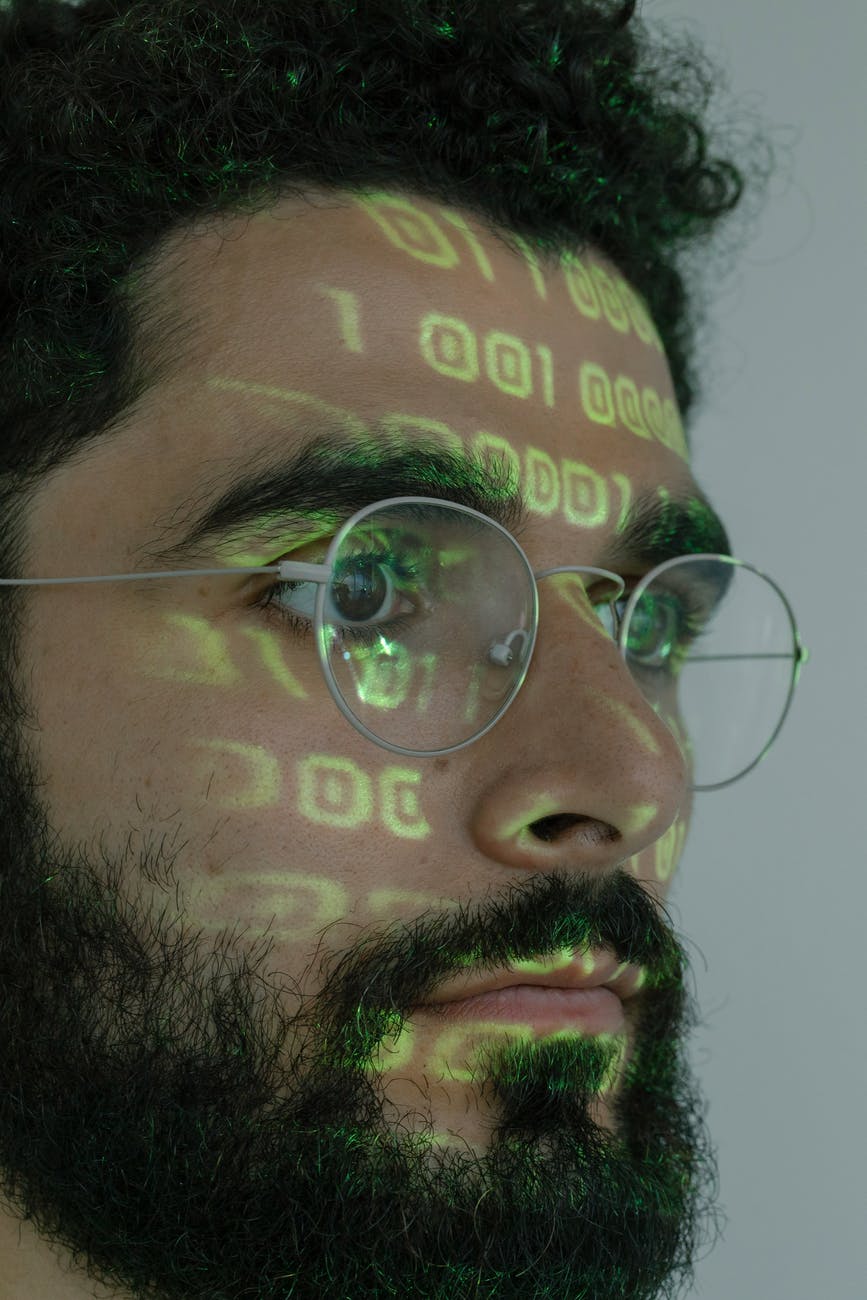 man with binary code projected on his face