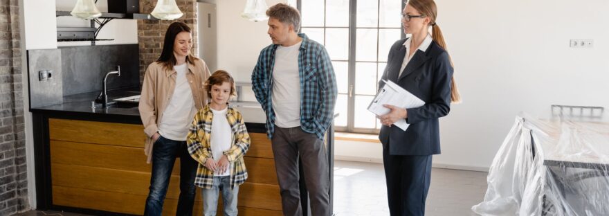 an agent talking to her clients inside the house