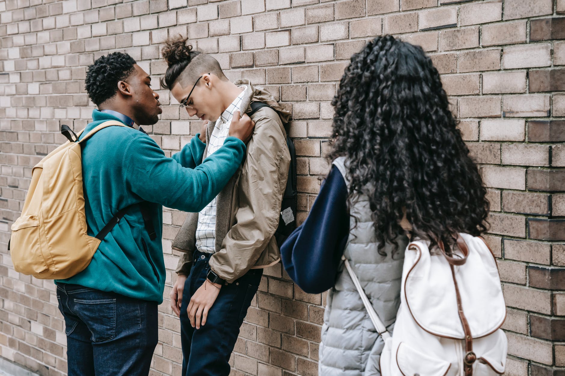 multiracial students having argument on street