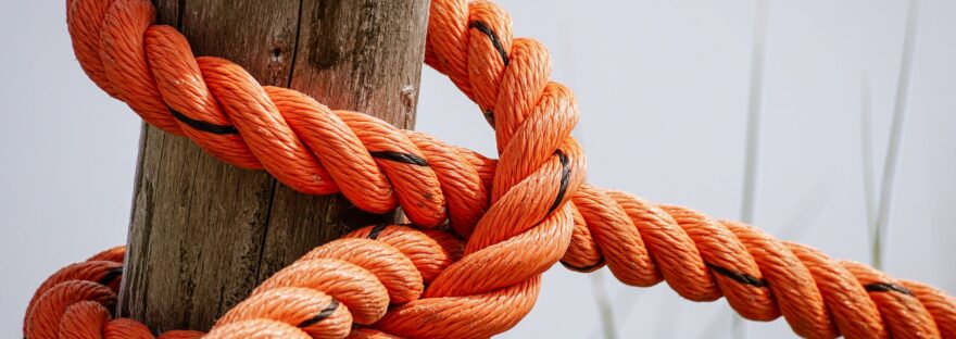 orange rope wrapped brown wood log